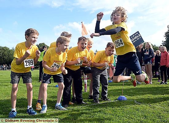 LEAP of faith . . . the Diggle team cheer on Regan Taylor in the standing jump