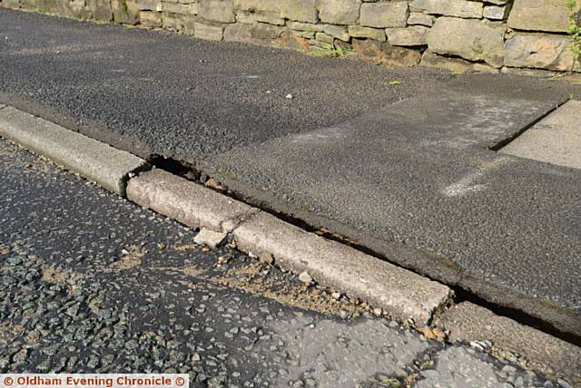 Damage caused by burst water main on Manchester Road, Greenfield at the junction with Dacres Road.