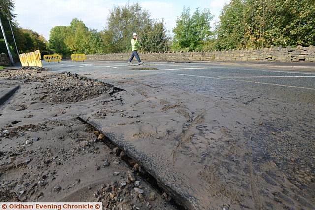 Damage caused by burst water main on Manchester Road, Greenfield at the junction with Dacres Road.