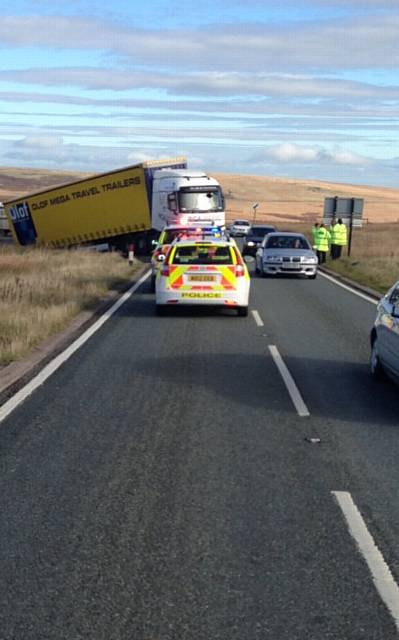 POLICE on the scene as the lorry remains stuck in the mud