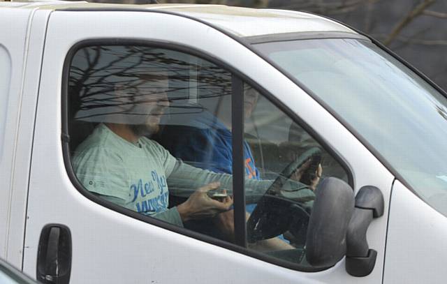 CRACKDOWN . . . a driver uses his mobile phone on Oldham Way