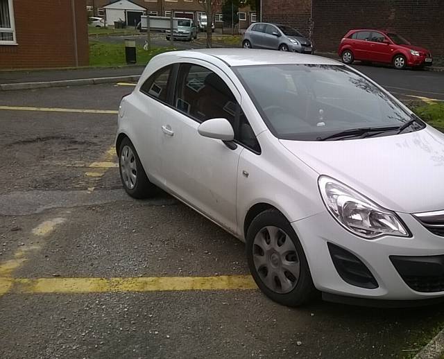 Suzanne Stankard photographed multiple cars parked on the yellow hashed spaces.