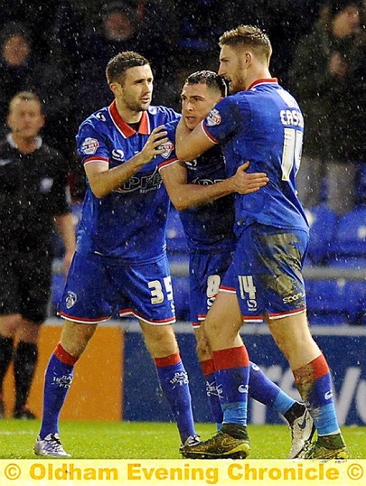 WELL DONE, MATE . . . Mike Jones (centre) is congratulated by his team-mates after scoring with a stunning free-kick (below).