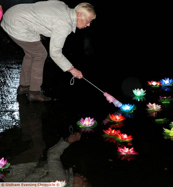 MOMENT to reflect . . . Liz Stevenson, from Oldham, setting off a remembrance candle in memory of her husband Chris who was looked after at Dr Kershaw's Hospice

