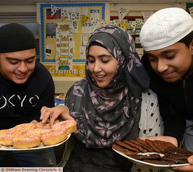 on-uniform day and cake sale for Children In Need, at Darul Hadis Latifiah North West Boys' School. Left to right, Uqbah Khan, Kalsoom Khan (organiser and head of English), Sahib Quddus
