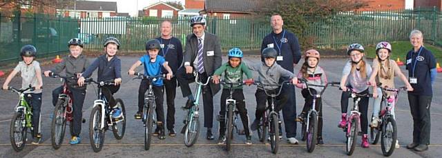 ON yer bike . . . Councillor Fida Hussain, with children from Corpus Christi R.C. Primary School on the Bikeability scheme