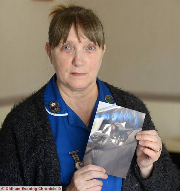 CONCERN . . . Ann Cooper with a photo of her cat Smokie which has been missing for several weeks
