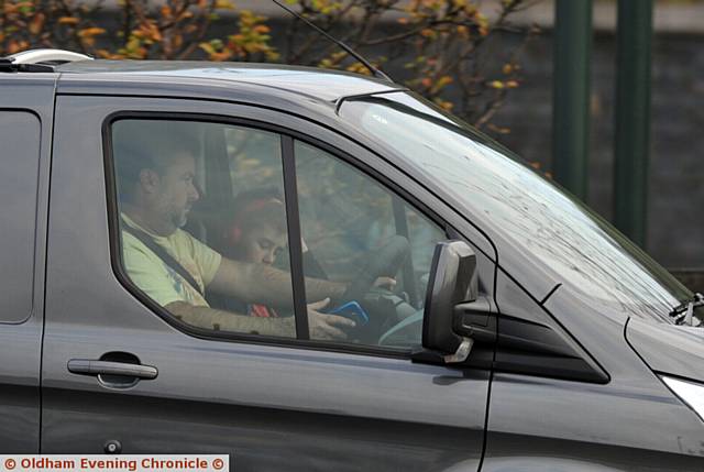 Drivers using mobile phones whilst driving on Oldham Way.