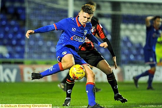 Brad Kay holds off his Bournemouth opponent.