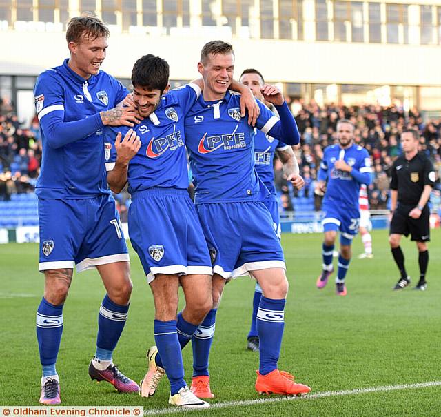 CENTRE OF ATTENTION . . . Ryan Flynn is mobbed by Lee Erwin (left) and Billy Mckay after putting Athletic in front
