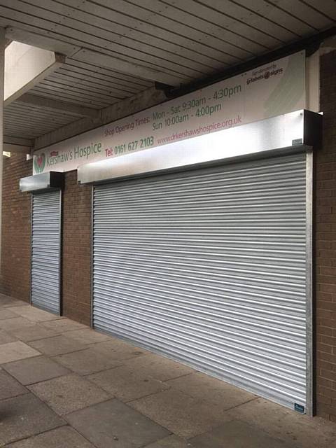 Company Alpine Security Systems install free roller shutters at Dr Kershaw's Hospice Shop, Chadderton Precinct, Middleton Road, following a break in during October which left the shop with thousands of pounds of damage
