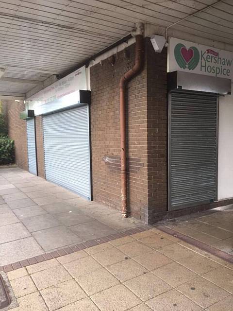 Company Alpine Security Systems install free roller shutters at Dr Kershaw's Hospice Shop, Chadderton Precinct, Middleton Road, following a break in during October which left the shop with thousands of pounds of damage
