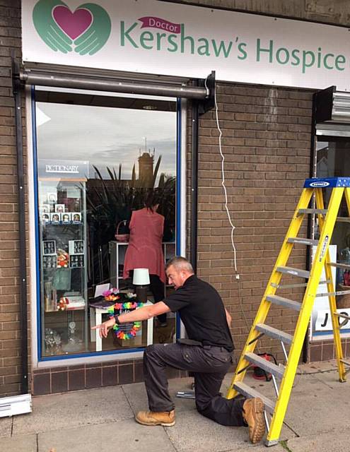 Company Alpine Security Systems install free roller shutters at Dr Kershaw's Hospice Shop, Chadderton Precinct, Middleton Road, following a break in during October which left the shop with thousands of pounds of damage
