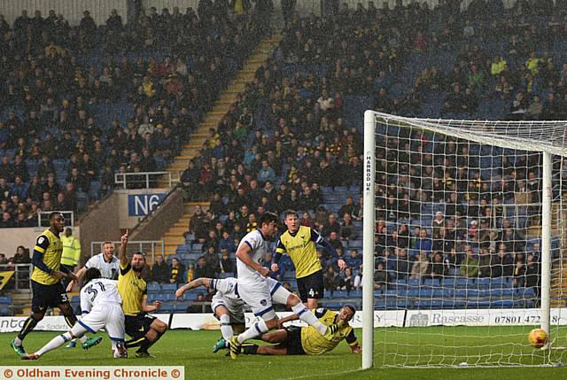 BACK OF THE NET . . . defender Cameron Burgess can't miss as he slots home for Athletic