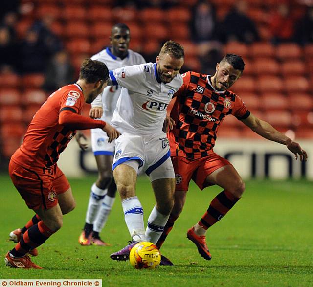 IN THE THICK OF THE ACTION . . . Athletic winger Ryan McLaughlin has a battle on his hands as he tries to charge forward