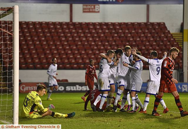 IN FRONT: Cameron Burgess (second left) is mobbed by his team-mates after putting Athletic in front at the Banks's Stadium last night. 