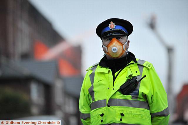 Fire at Maple Mill, Hathershaw. PCSO with mask.