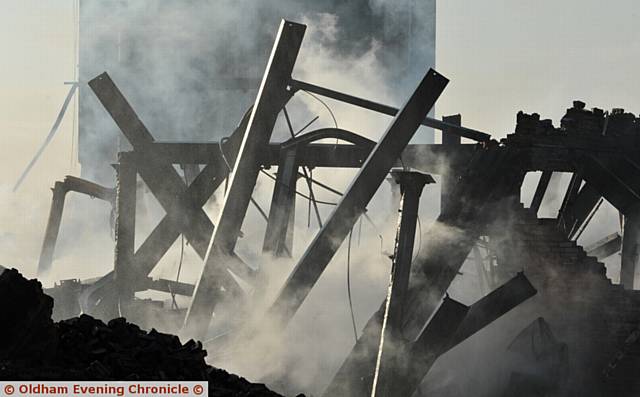 DEVASTATION . . . up close at Maple Mill where smoke continues to rise from the debris