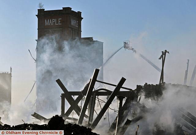 DEVASTATION . . . up close at Maple Mill where smoke continues to rise from the debris