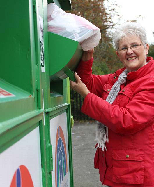 GOOD CAUSE . . . Maureen Mullin uses one of the Francis House textile banks