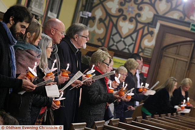 Christingle and Crib service at Oldham Parish church. Pic shows, The congregation line up around the church during the carol service.