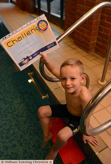 MAKING a splash . . . young Ryan Taylor has completed his gold swimming award