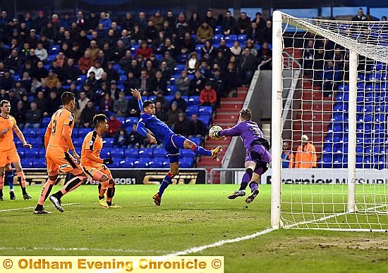 ON THE STRETCH . . . Timothee Dieng tries to get on the end of a cross into the penalty box, but is denied by Colchester goalkeeper Elliott Parish. 