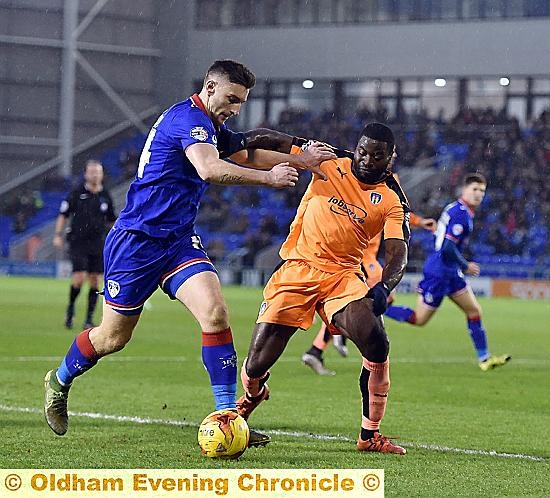 MY BALL . . . Jake Cassidy shows strength and determination to hold off the challenge of George Elokobi.