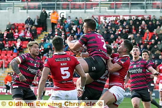 HIGH BALL: Oldham winger Adam Clay climbs to defuse a potentially tricky situation.