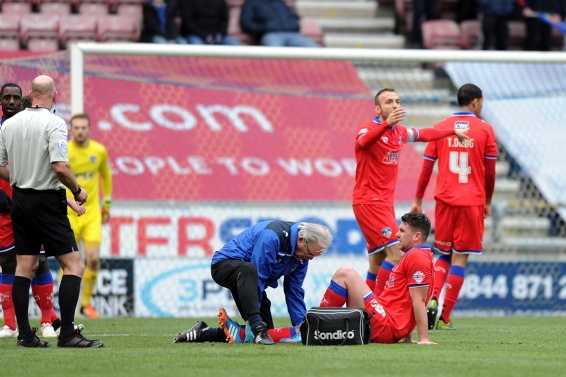 PAINFUL BLOW . . . Anthony Gerrard receives treatment to his knee before leaving the field. 