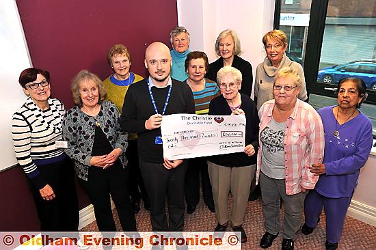 CANCER boost . . . Daniel Poole, The Christie fundraising manager, receives the cheque from Mildred Taylor, the committee’s longest-serving member