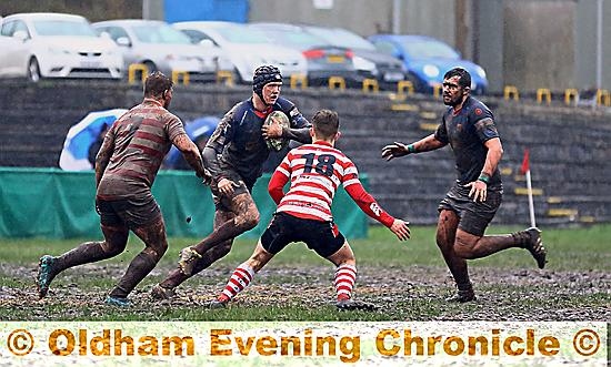 SQUELCH . . . Ryan Arundale shows neat footwork on the boggy pitch.
