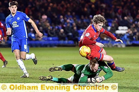 Matt Palmer is bundled over in the box by Posh ’keeper Ben Alnwick for a penalty