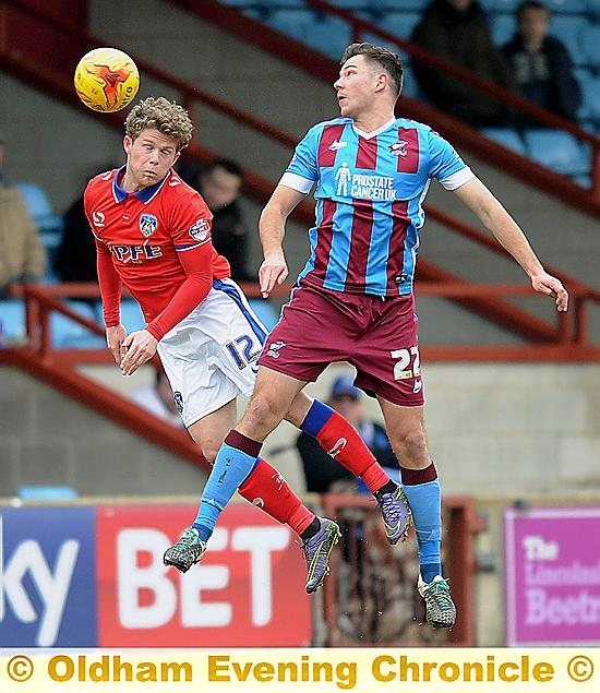 up and at ’em . . . Matt Palmer wins a header against Scunthorpe on Saturday.