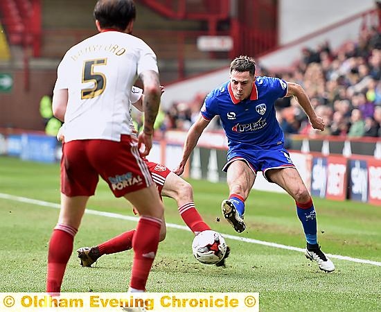 ATHLETIC’S Mike Jones tries to thread a pass through the Blades line.