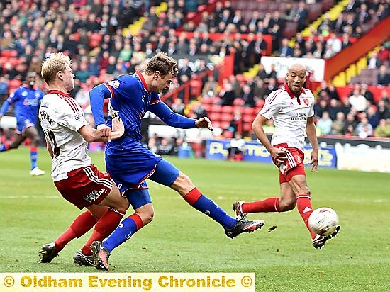 New loan signing Timmy Thiele forces his way into the Blades penalty box.