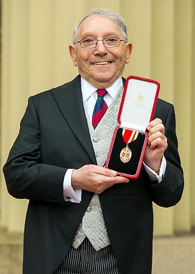 PROUD moment... Oldham icon Norman Stoller receives his knighthood.