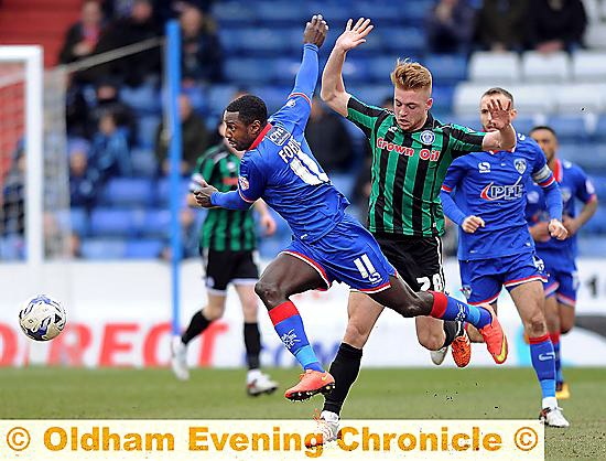 Athletic forward Jonathan Forte runs across his Rochdale rival in the Sky Bet League One clash.
