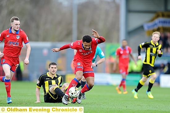 AARON Amari-Holloway battles for the ball at Burton Albion.