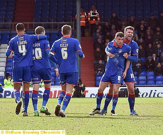 YOU BEAUTY: defender Anthony Gerrard grabs hold of Mike Jones after the midfielder’s match-winner against Chesterfield. 