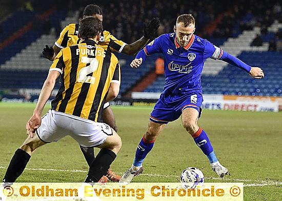 IN CONTROL . . . Liam Kelly skips past two Port Vale opponents.