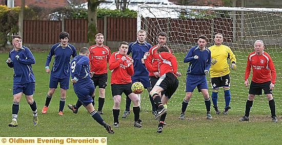 ACTION STATIONS . . . it’s a packed penalty box as Royton Athletic fire in a free-kick. 