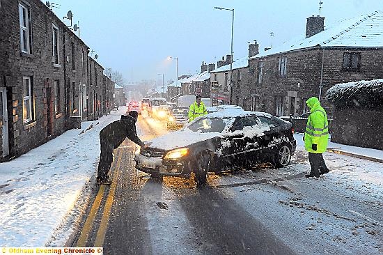 A CAR gets stuck in the snow on Oldham Road, Springhead