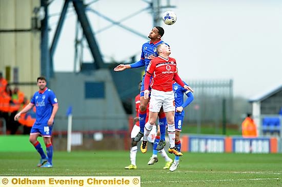 HEAD AND SHOULDERS. . . Timothee Dieng wins his aerial battle.
