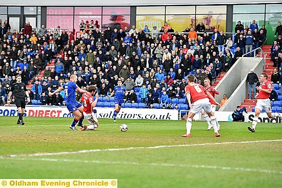 MAIN MAN . . . Curtis Main fires the only goal of the game through the Walsall blockade.
