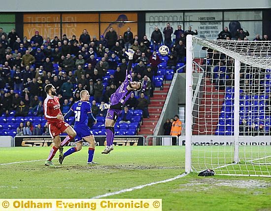 THAT’S THE CLINCHER . . . Curtis Main nods the ball over Swindon ‘keeper Tyrell Belford to make it 2-0 to Latics.