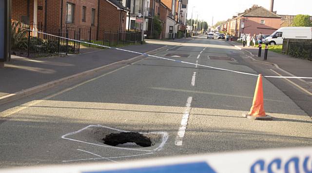 CORDONED... Police close Field New Road after deep sinkhole appears.
