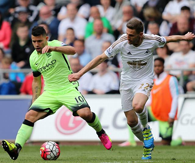 HOLD OFF . . . City’s Sergio Aguero (left) and Swansea’s Angel Rangel battle for the ball during the Premier League match at the Liberty Stadium.
