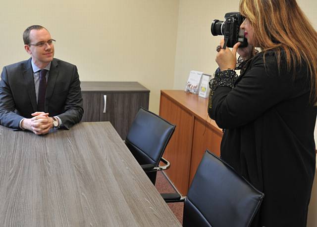 OUR photorapher for the day...Solicitor Aaron Marshall at Pearson Solicitors, Hollinwood poses for MayoressYasmin Toor, shadowing photographic department for the day.