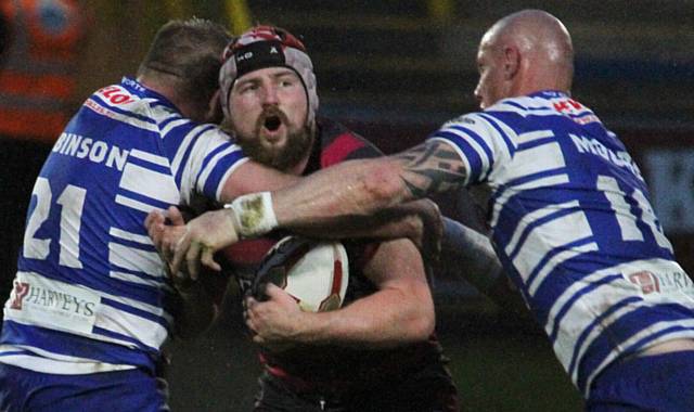 NO WAY THROUGH... Oldham's Michael Ward runs into trouble